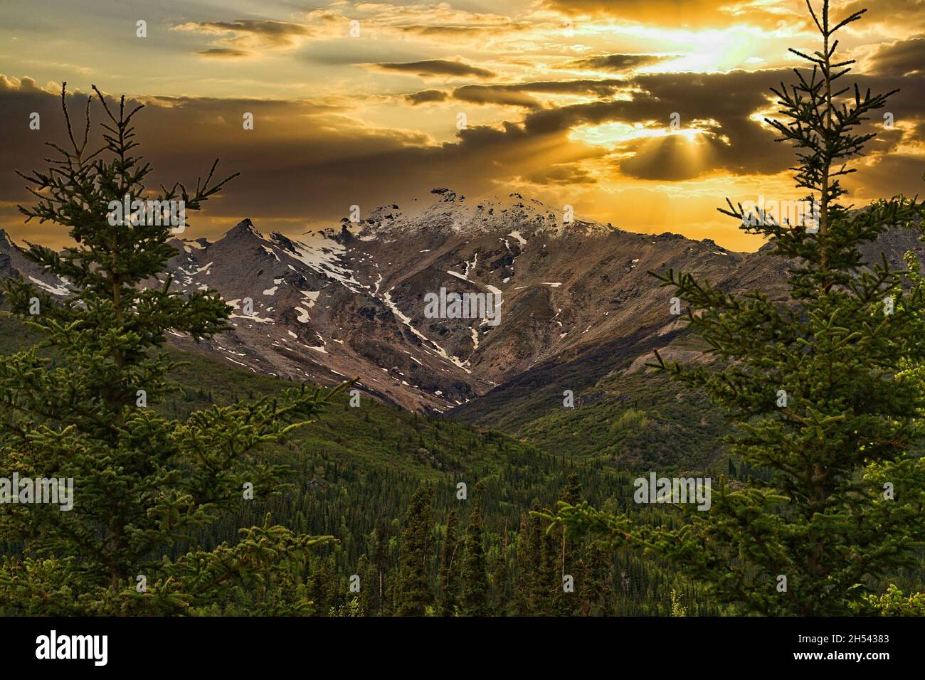 Sun setting over the mountains in Denali National Park Stock Photo