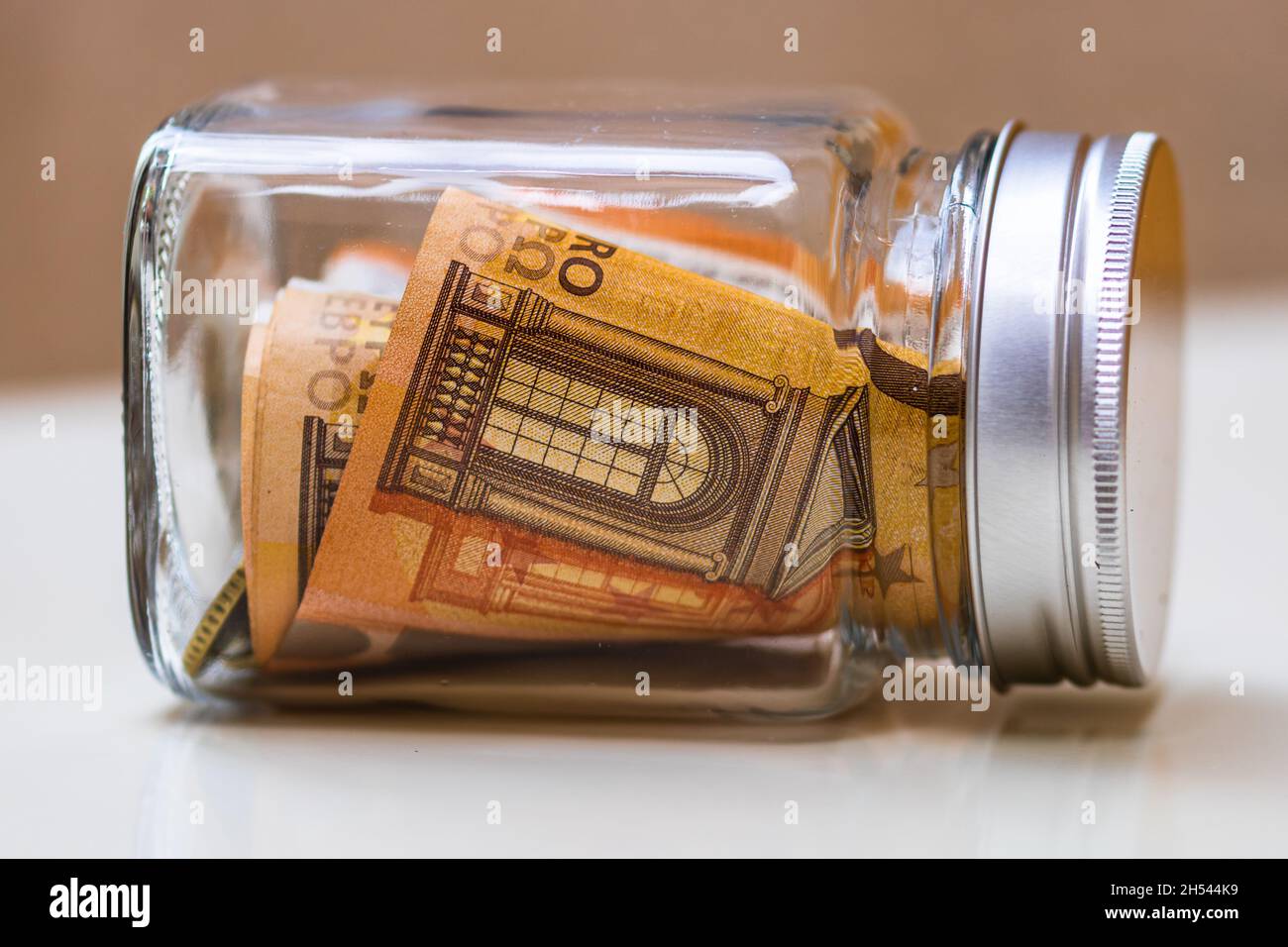Composition with saving money banknotes in a glass jar Stock Photo - Alamy