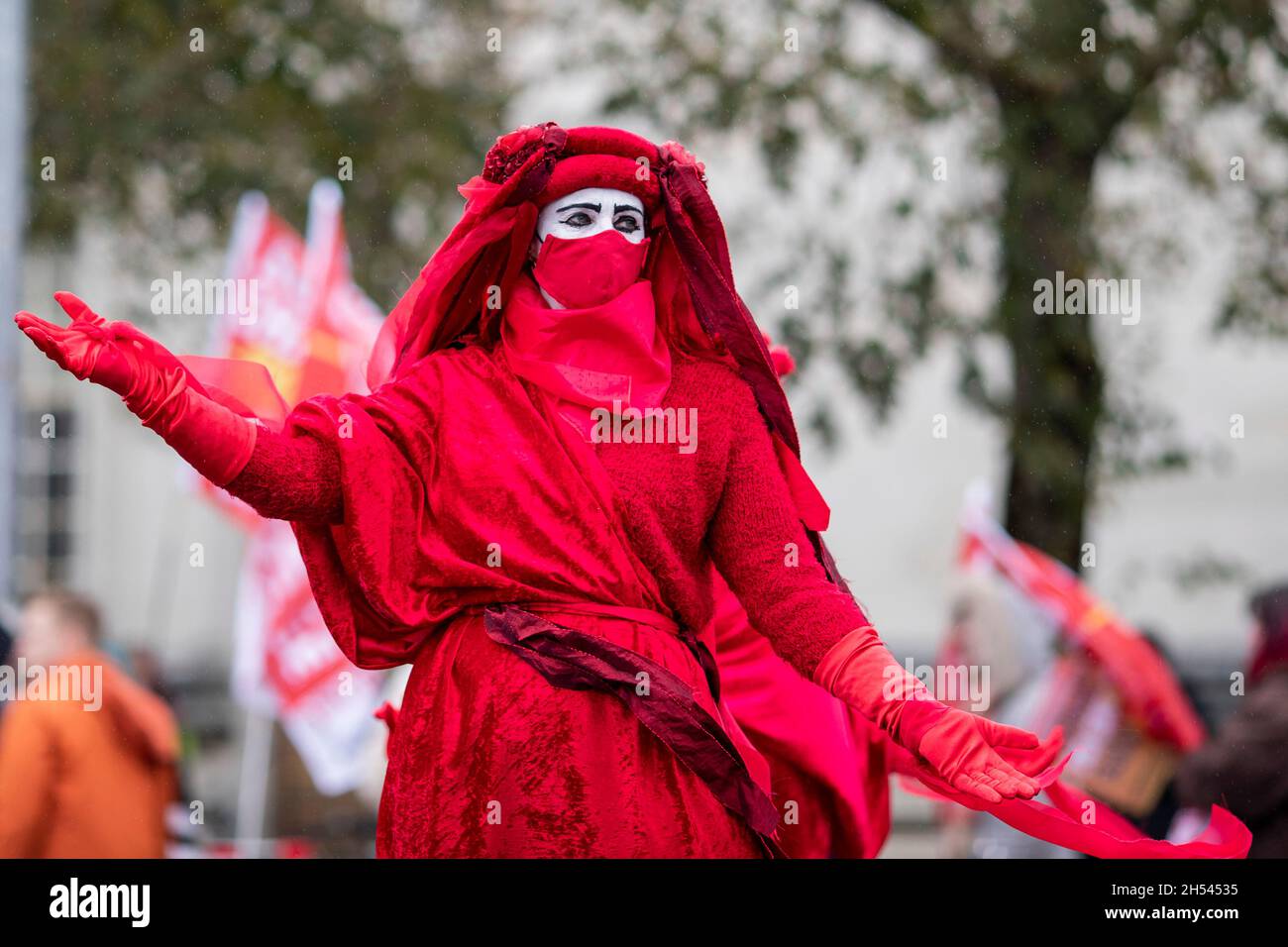 Cardiff, Wales, UK. 06th Nov, 2021. A member of Extinction Rebellion's red rebel brigade in Cardiff city centre as part of coordinated global activism during the COP26 summit in Glasgow, Scotland. Credit: Mark Hawkins/Alamy Live News Stock Photo