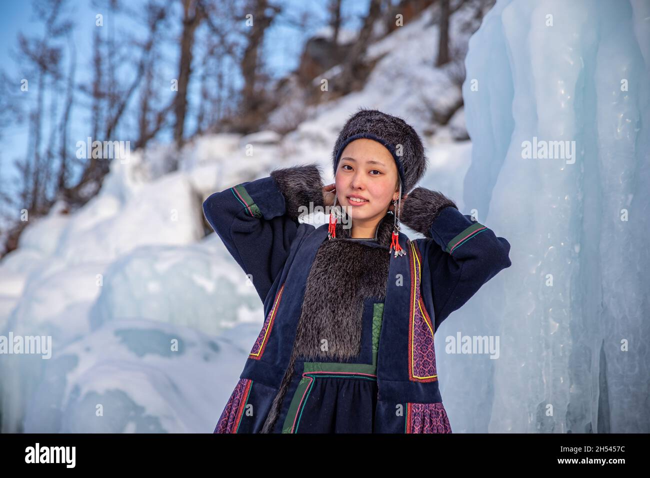 A Portrait of Buryat girl standing on the icy cost on a little island on Baikal Lake in winter time Stock Photo
