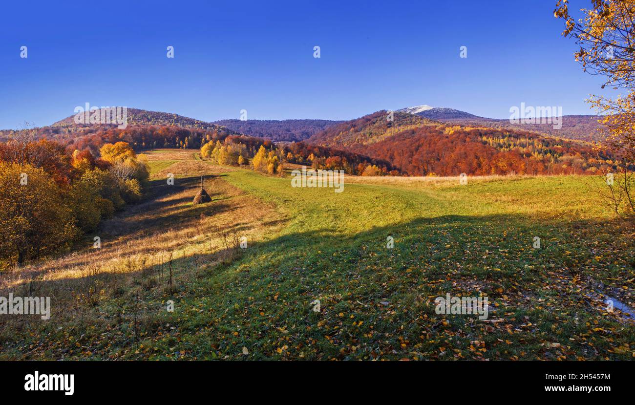 View of hills of Water Dividing ridge covered in red, orange and yellow ...