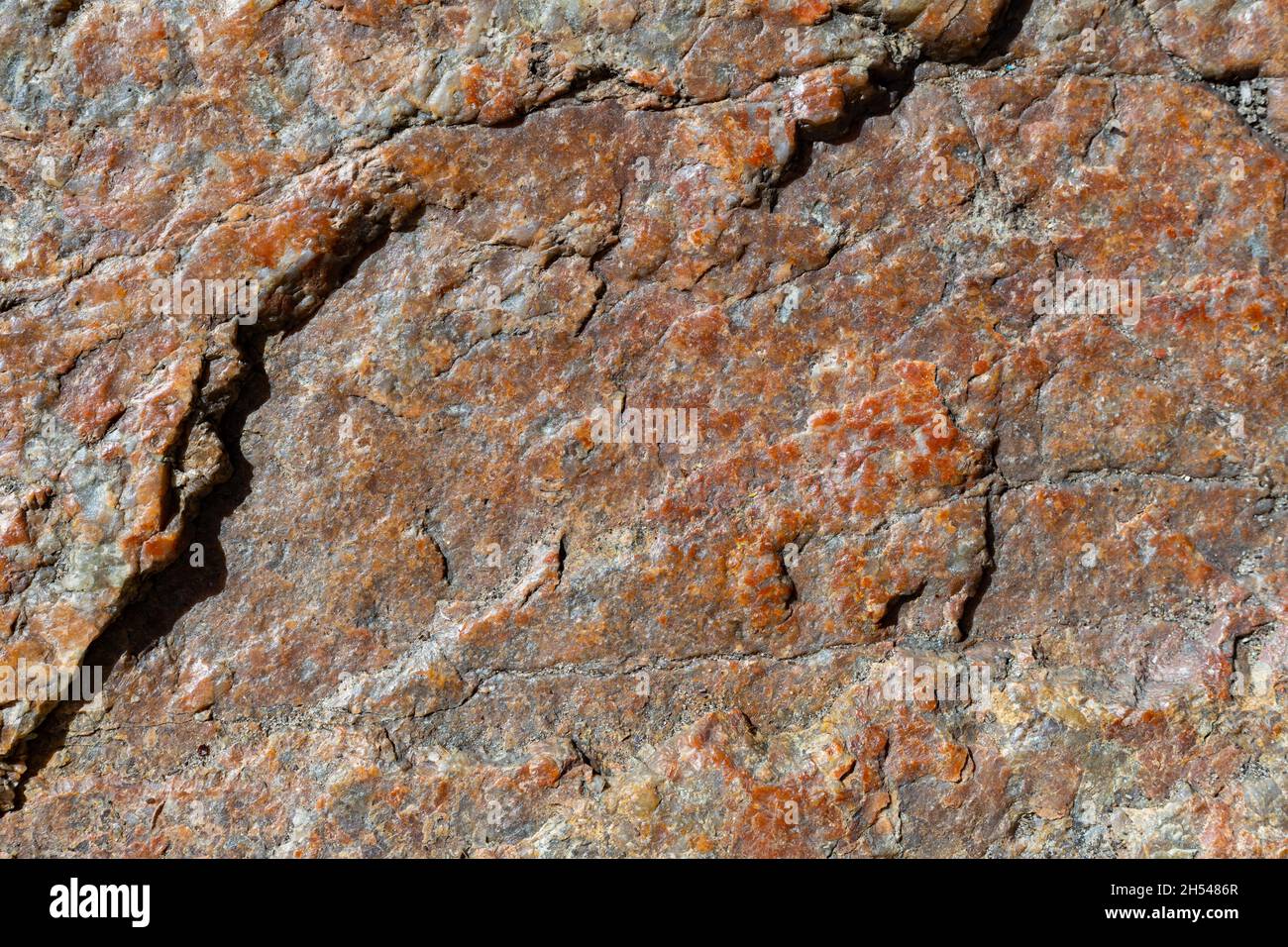 Texture of granite rock. Cracked stone surface from weathering. Close