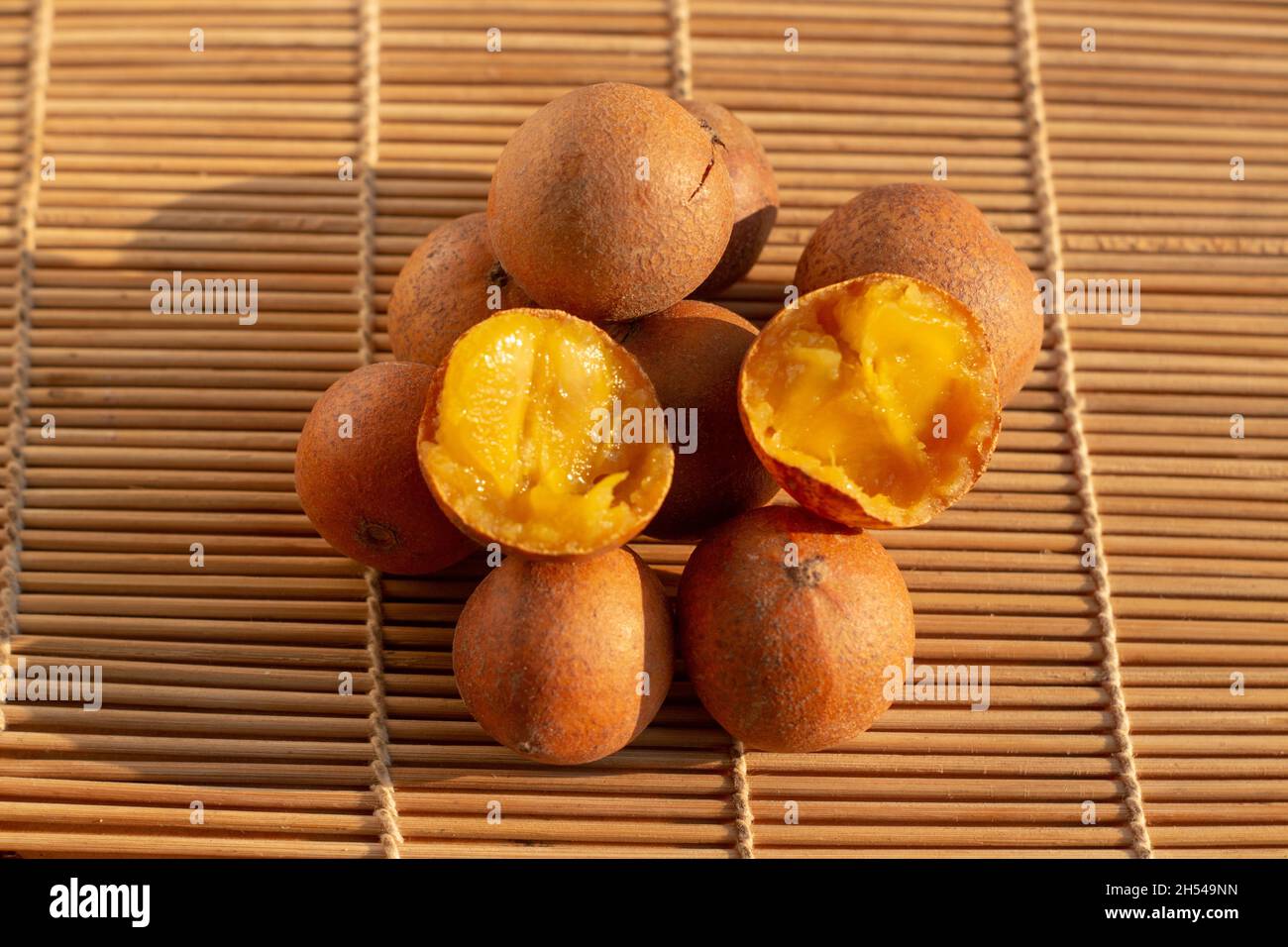 African wild fruits known as mazhanje or masuku (Uapaca kirkiana) revealing the yellow sweet pulp Stock Photo