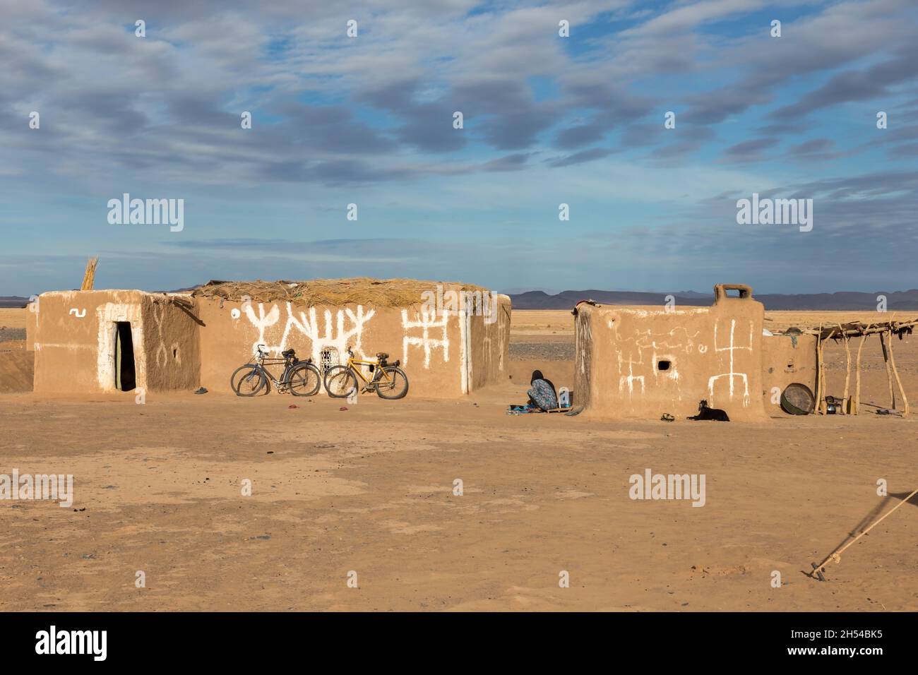 Errachidia Province, Morocco - October 23, 2015: Berber huts in the Sahara Desert. There are bicycles near the wall of the house. Stock Photo