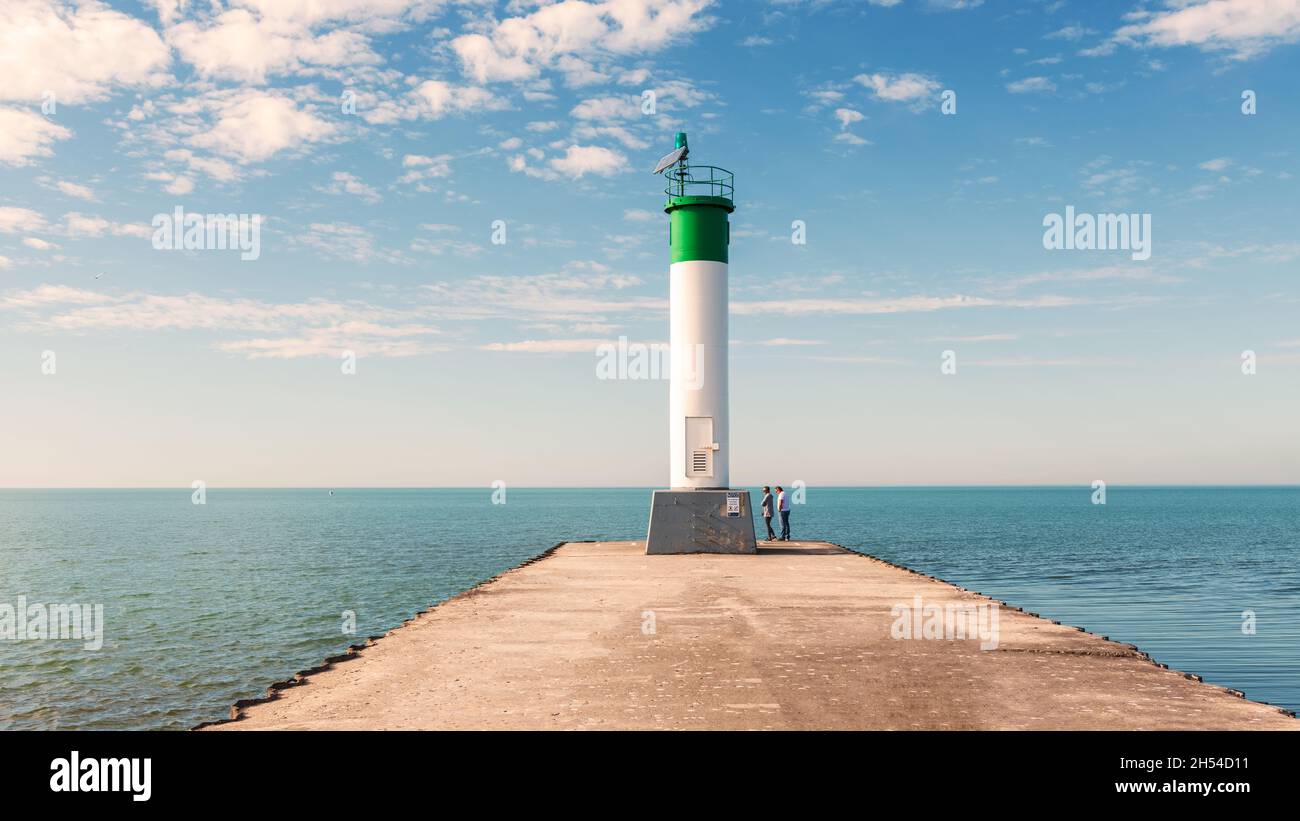 Grand Bend, Ontario, Canada - Nov 9, 2020: People vositing Lighthouse at the end of the pier on Lake Huron in Grand Bend, Ontario, Canada Stock Photo