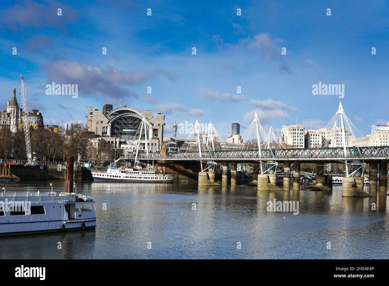 LONDON - JANUARY/18 /2021 : View towards Charing Cross Staion and Hungerford Bridge in London. golden jubilee bridge Stock Photo
