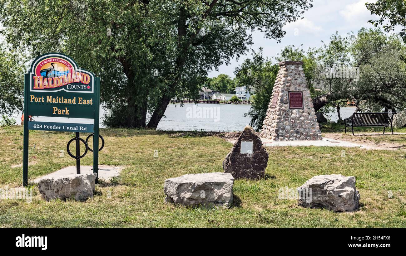 Port Maitland, Canada – July 1, 2021: View at the sign in Port Maitland East Park with Grand River entering Lake Erie at the background, Ontario, Cana Stock Photo