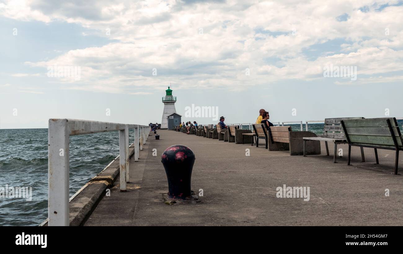 Port Dover, Canada-August 3, 2021: People visiting heritage lighthouse in Port Dover  West Pier on Lake Erie, Ontario, Canada. Stock Photo