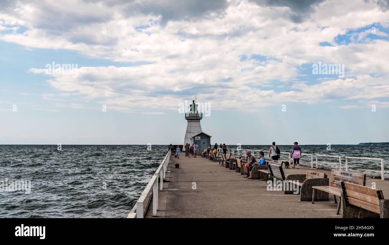 Port Dover, Canada-August 3, 2021: People visiting heritage lighthouse in Port Dover  West Pier on Lake Erie, Ontario, Canada. Stock Photo