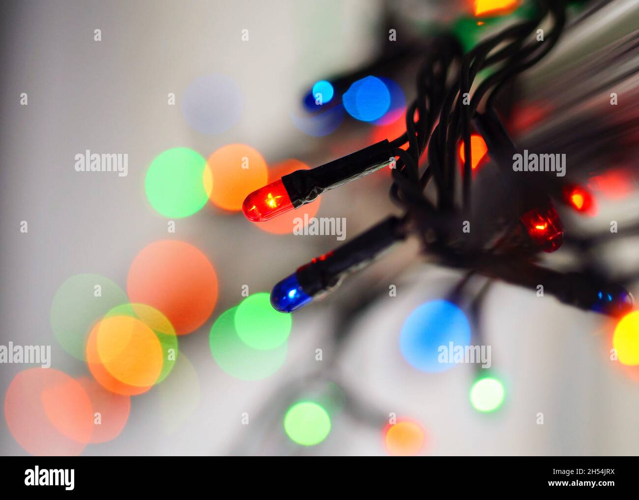 Blurred colored bright lights. Bokeh and art wallpaper concept. Christmas concept. Red, blue, green, orange lights. Stock Photo