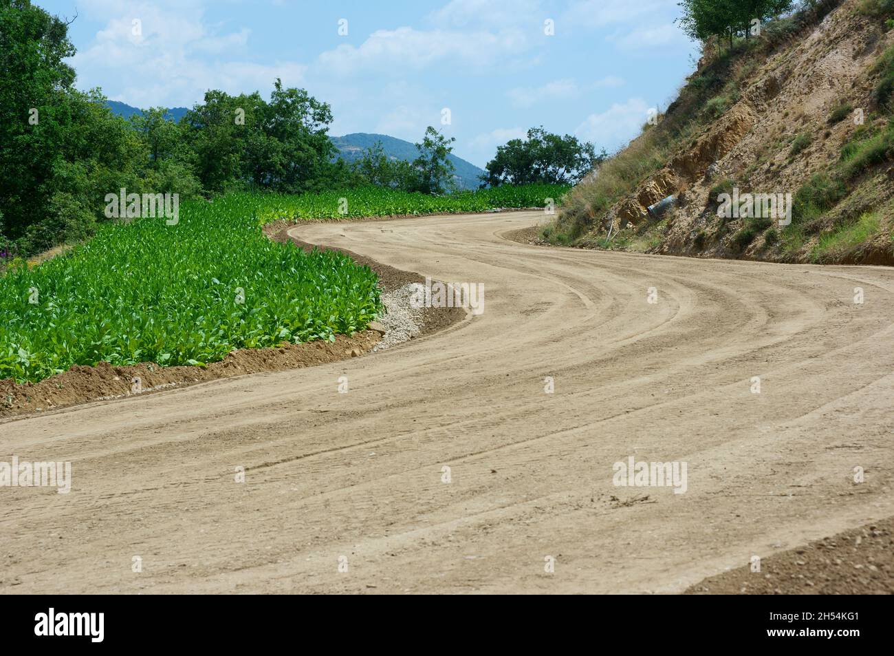 base soil compacted and ready to asphalting winding mountain road  in the north of Greece Stock Photo