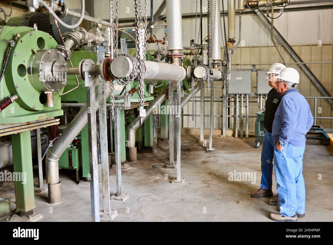Worker inspecting equipment at Adkins Energy Ethanol plant that turns