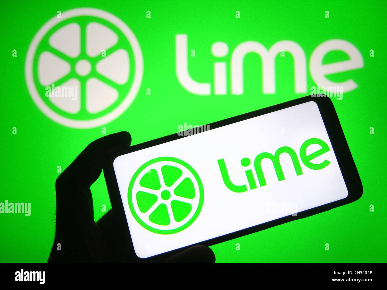 In this photo illustration a Lime (Neutron Holdings, Inc.) logo of a car  sharing company is seen on a smartphone screen Stock Photo - Alamy