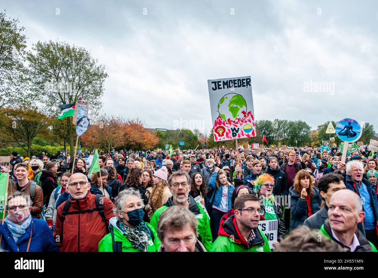 Protesters seen listening to speeches at the Westerpark during the demonstration.The march is organized by the Dutch Climate Crisis Coalition, which is collaboration between eleven different organizations and groups. This demonstration is taking place at the same time that the UN Climate Change Conference in Glasgow, to make a call for a drastic change and to demand that the Dutch government take action now, in the shape of ambitious and fair climate policies. This was the biggest climate demonstration in the country. (Photo by Ana Fernandez/SOPA Images/Sipa USA) Stock Photo