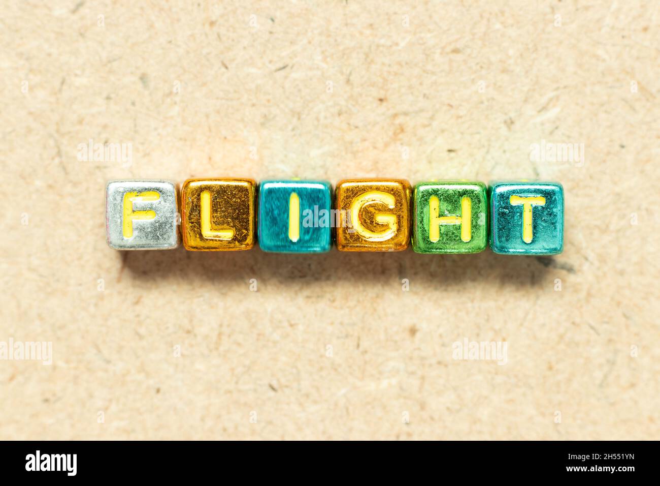 Metallic color alphabet letter block in word flight on wood background Stock Photo