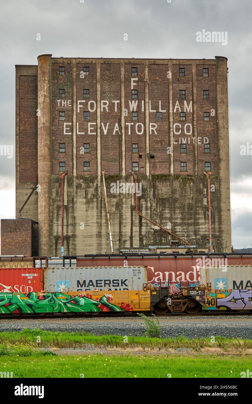 CP Rail freight train passes grain elevators in Thunder Bay Ontario. Stock Photo