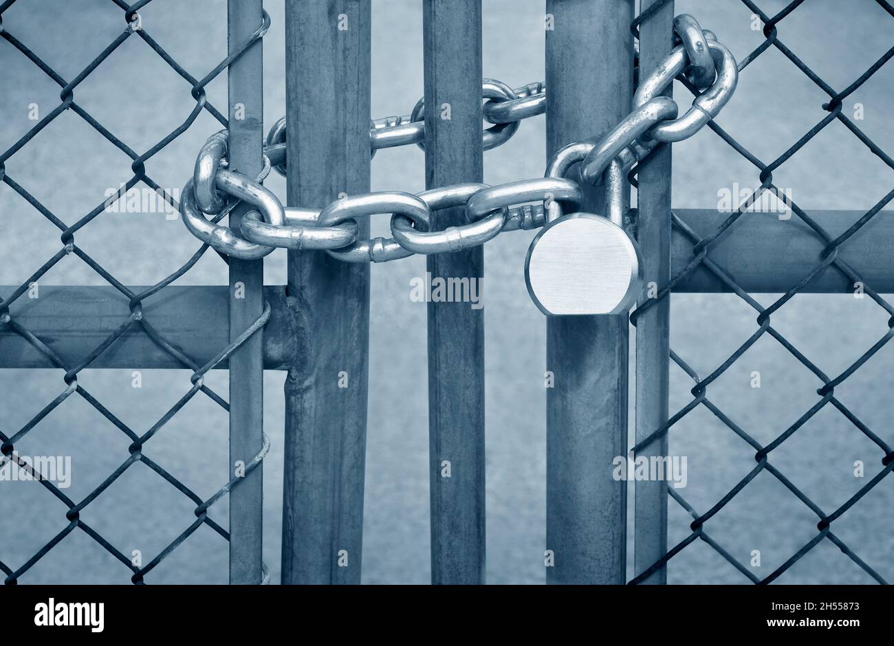 A padlocked chainlink fence gate Stock Photo