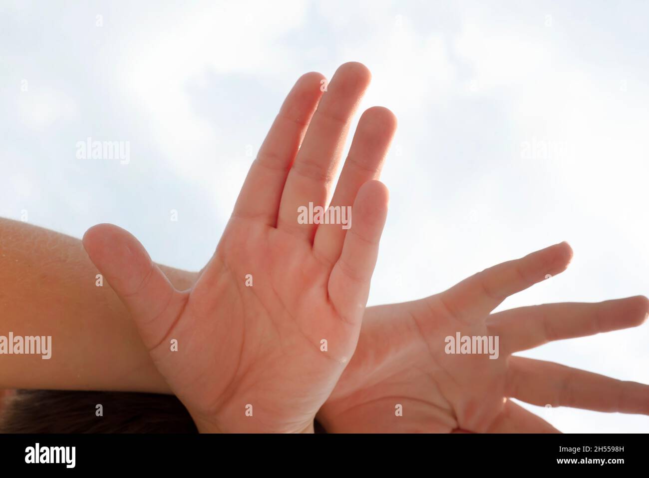 Human palms. Hands on the background of the sky. Stock Photo