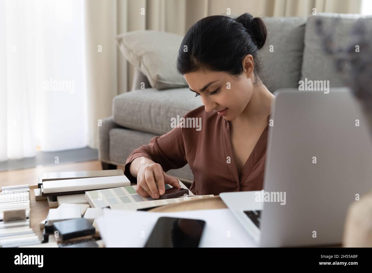 Indian female architect or interior designer choosing tiles samples Stock Photo