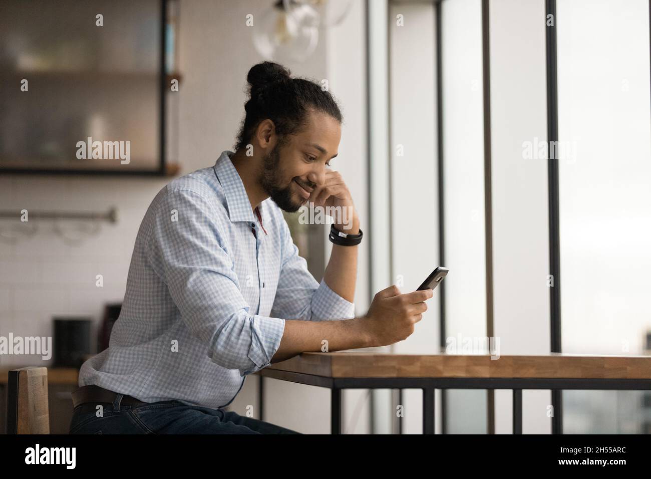 Happy young african american man using cellphone. Stock Photo