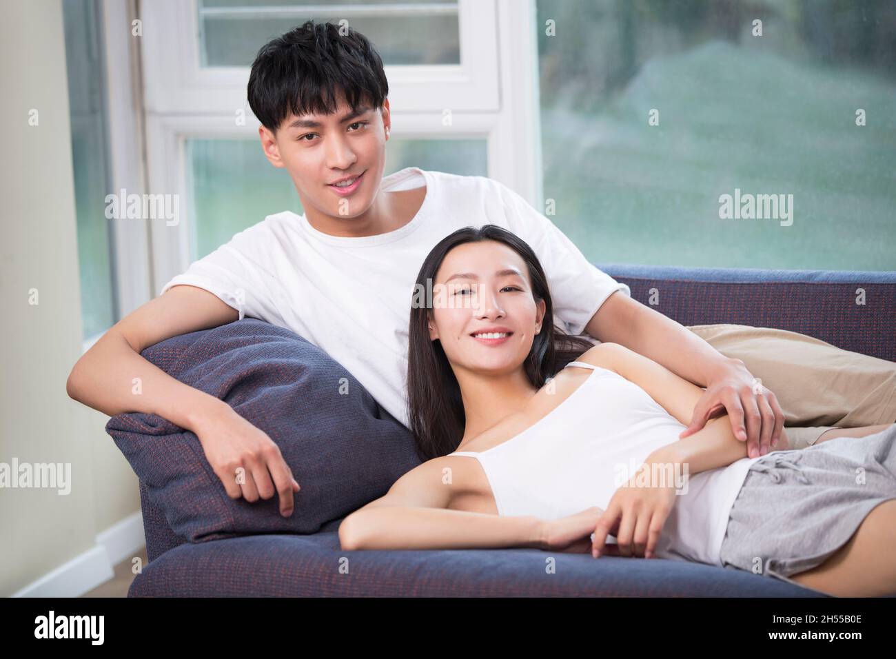 Young couple relaxing on the sofa Stock Photo