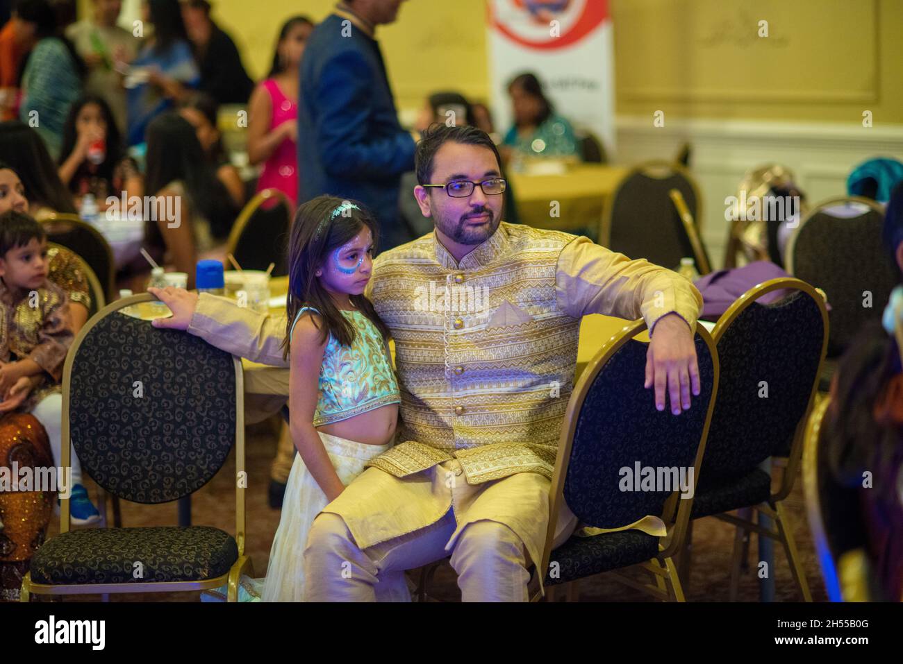 From left, Naval Dhawan and Naya Dhawan watch a band perform during a