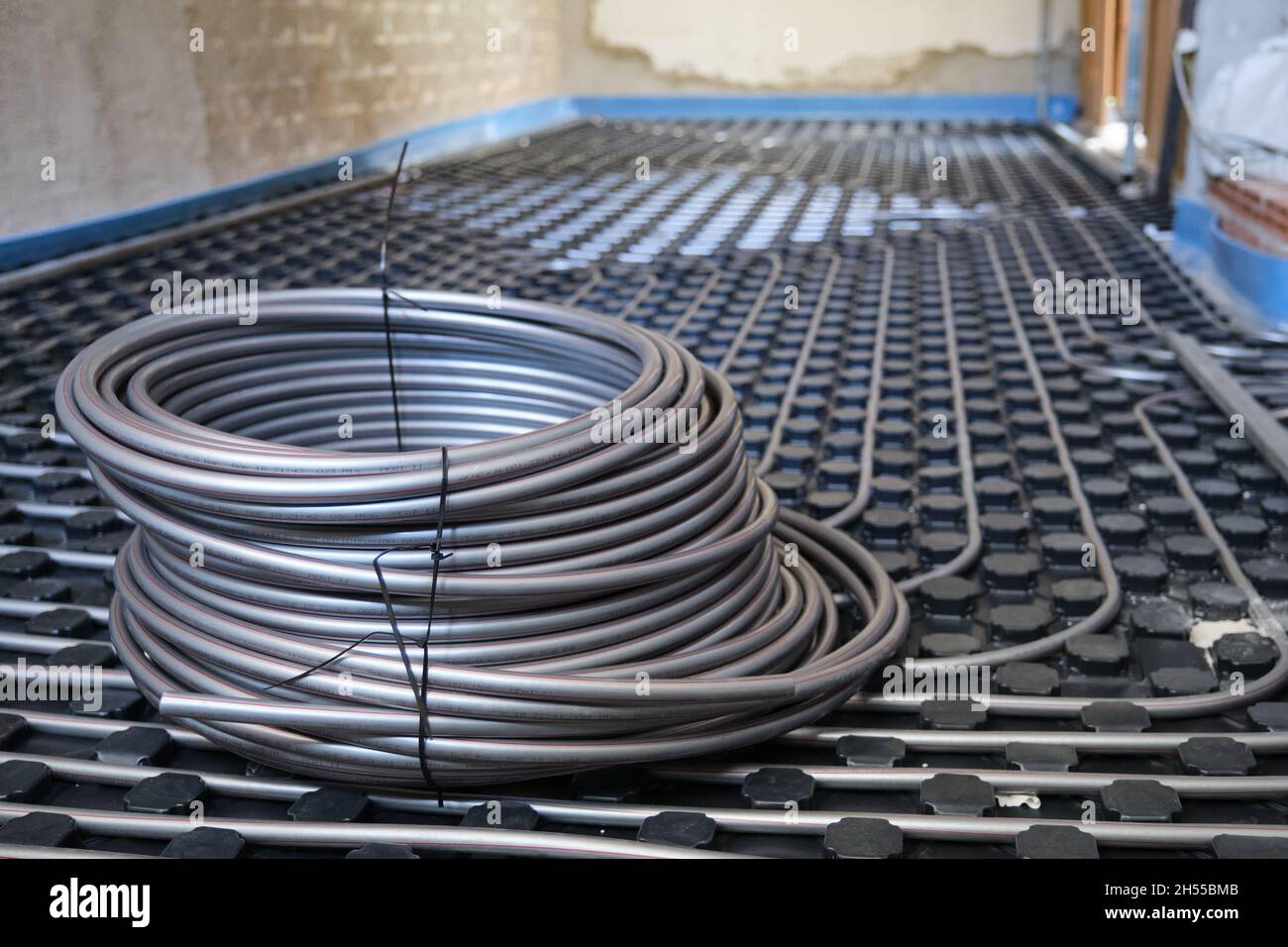 Underfloor heating system pipes on insulation. Radiant floor Stock