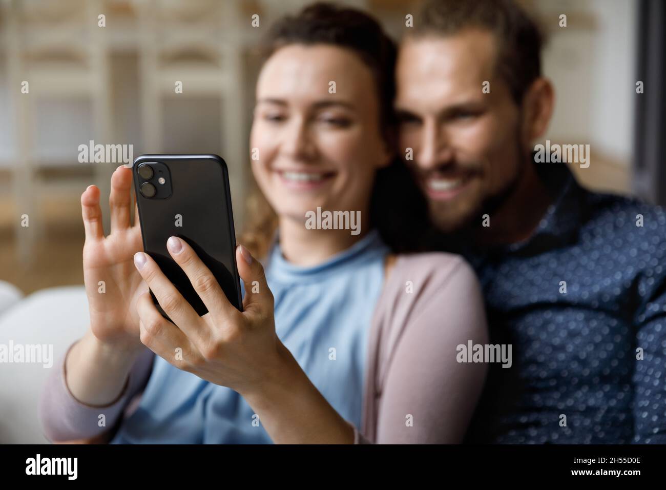 Close up happy young couple using cellphone. Stock Photo