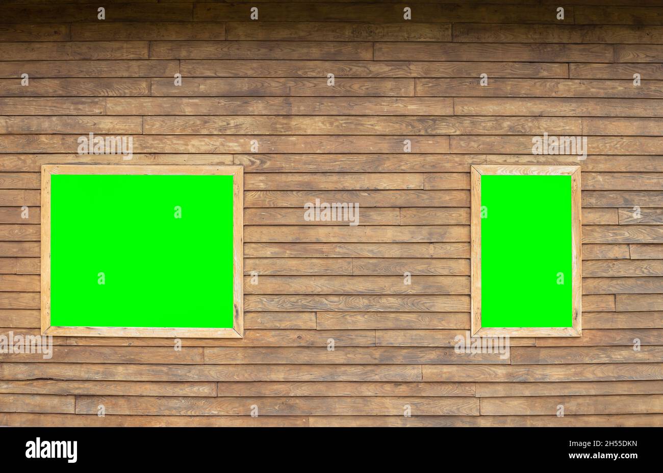 A horizontal image of a wooden background with two framed windows on which there is a green chroma key for attaching images or video. copy space Stock Photo