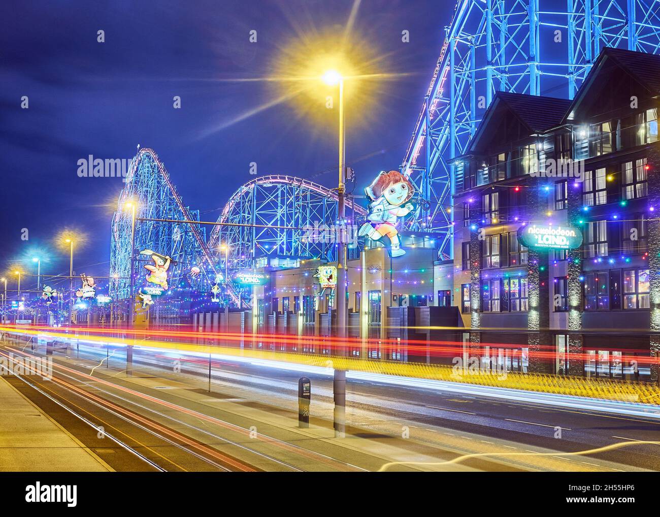 Tram and car light trails in front of the Big One roller coaster during Blackpool illuminations Stock Photo