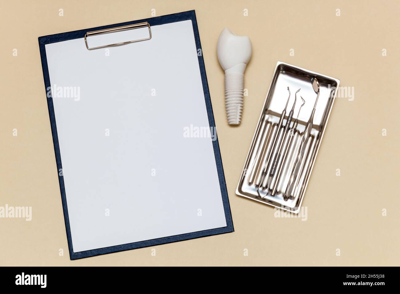 Mockup of dental implant and folder with clip for paper sheets A4 on ...