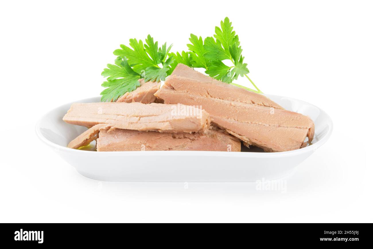 Tuna fillets in olive oil with parsley isolated on white background. Stock Photo