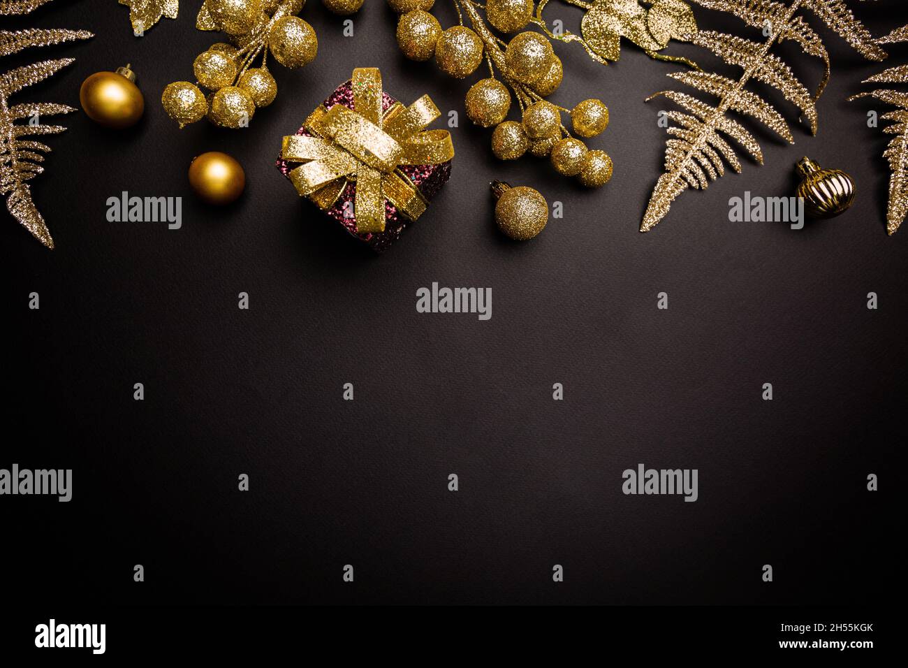 Christmas holidays composition with gold decorations on black ...