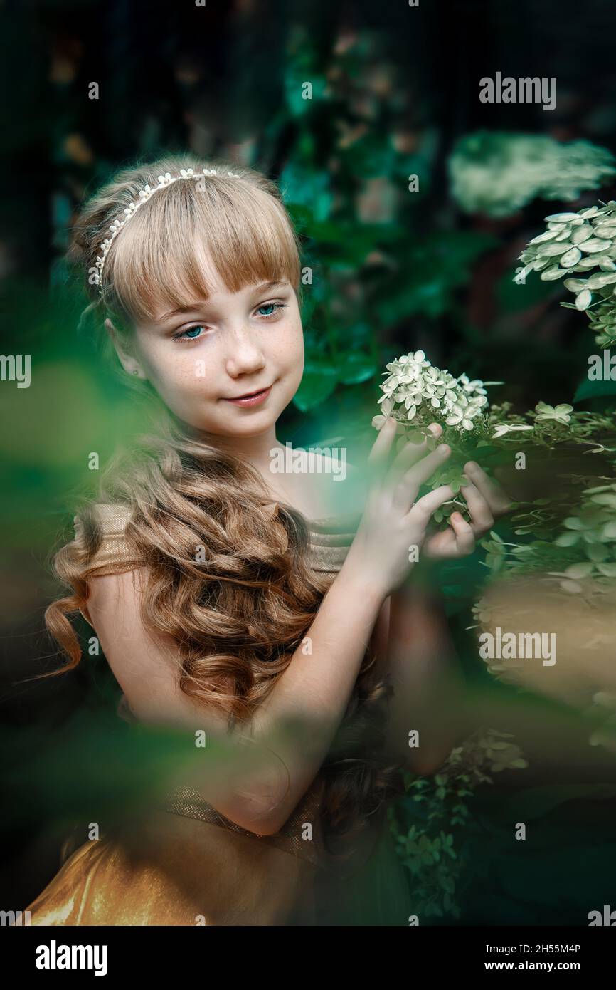 Beautiful 11 Year Old Girl With Long Blonde Hair In Hydrangea Flowers