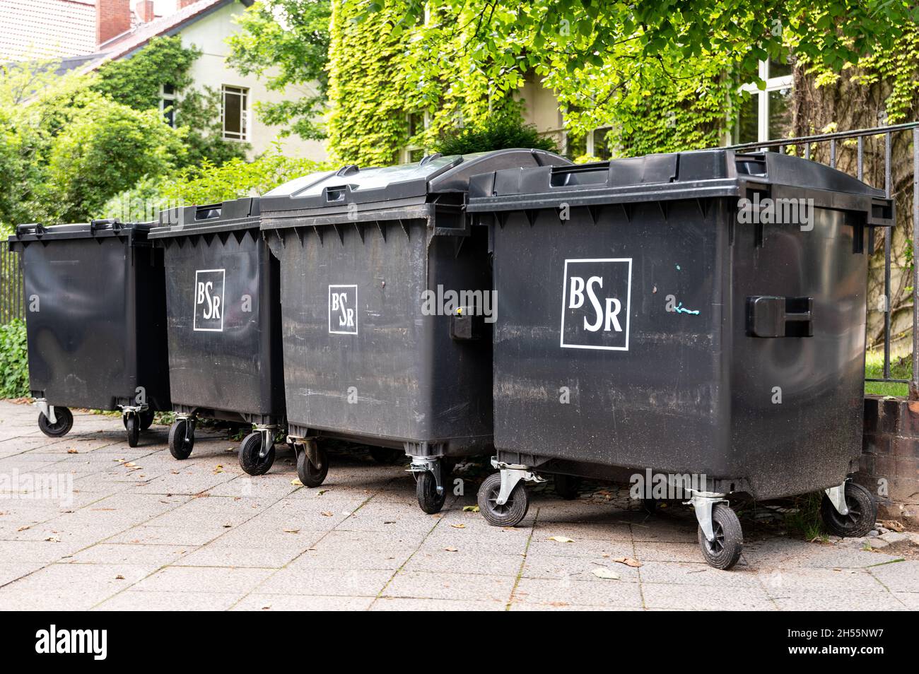 four rubbish bins from the BSR. BSR is the Berlin city cleaning service Stock Photo