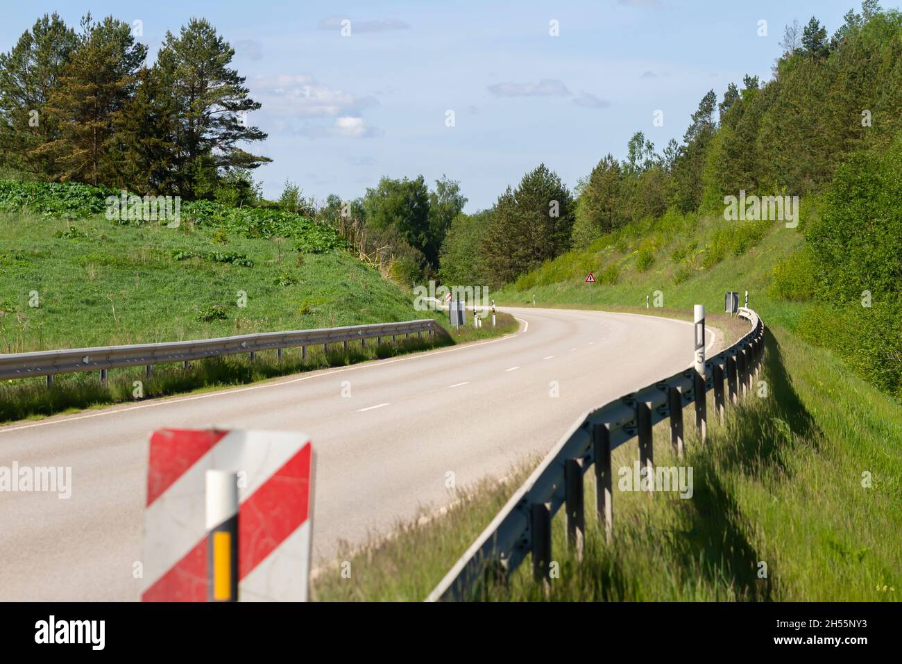 View to curve road with borders Stock Photo - Alamy