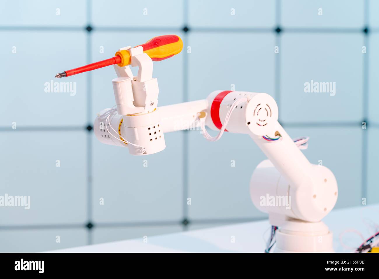 Robot hand with a screwdriver. The concept of automation of work on ...