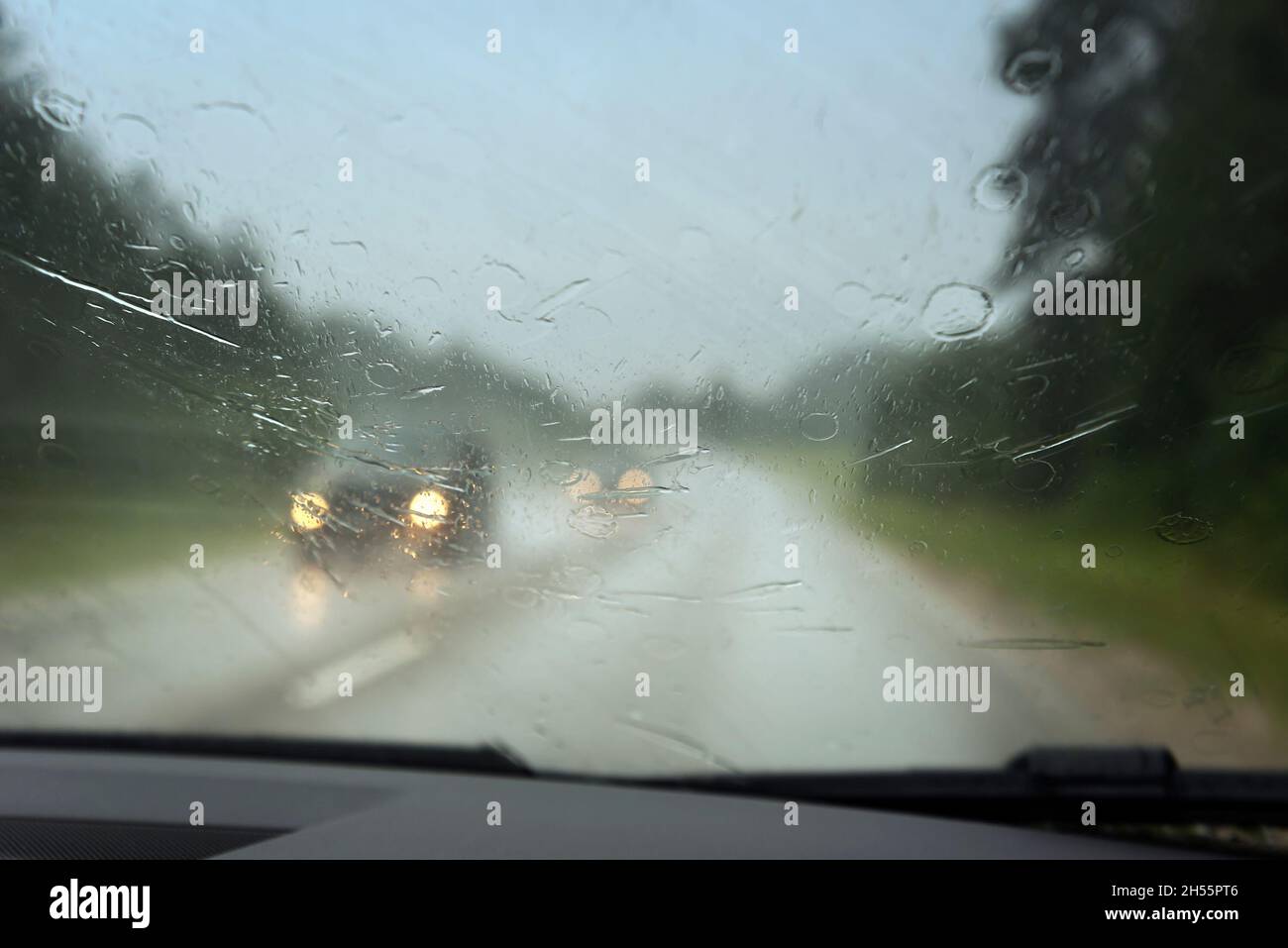 View to road through car window in rainy day Stock Photo - Alamy