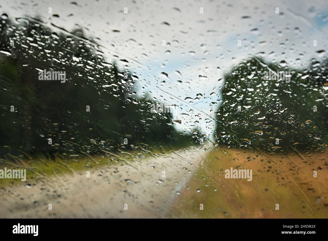 View to road through car window in rainy day Stock Photo - Alamy