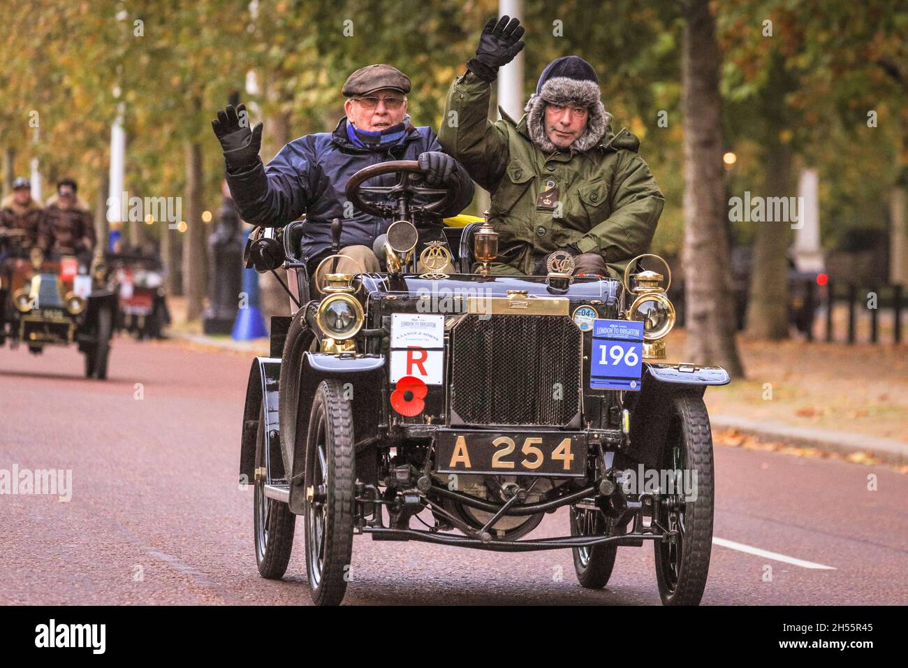 Westminster, London, UK. 07th Nov, 2021. George Beale and passenger in their 1904 Peugeot. The veteran cars on The Mall, leading away from Buckingham Palace. This year marks the 125th anniversary of the historic London to Brighton Veteran Car Run. To mark the occasion, more than 320 pioneering ‘horseless carriages' from the dawn of motoring will Hyde Park in London at sunrise and make the same journey to Brighton on the Sussex coast. Credit: Imageplotter/Alamy Live News Stock Photo