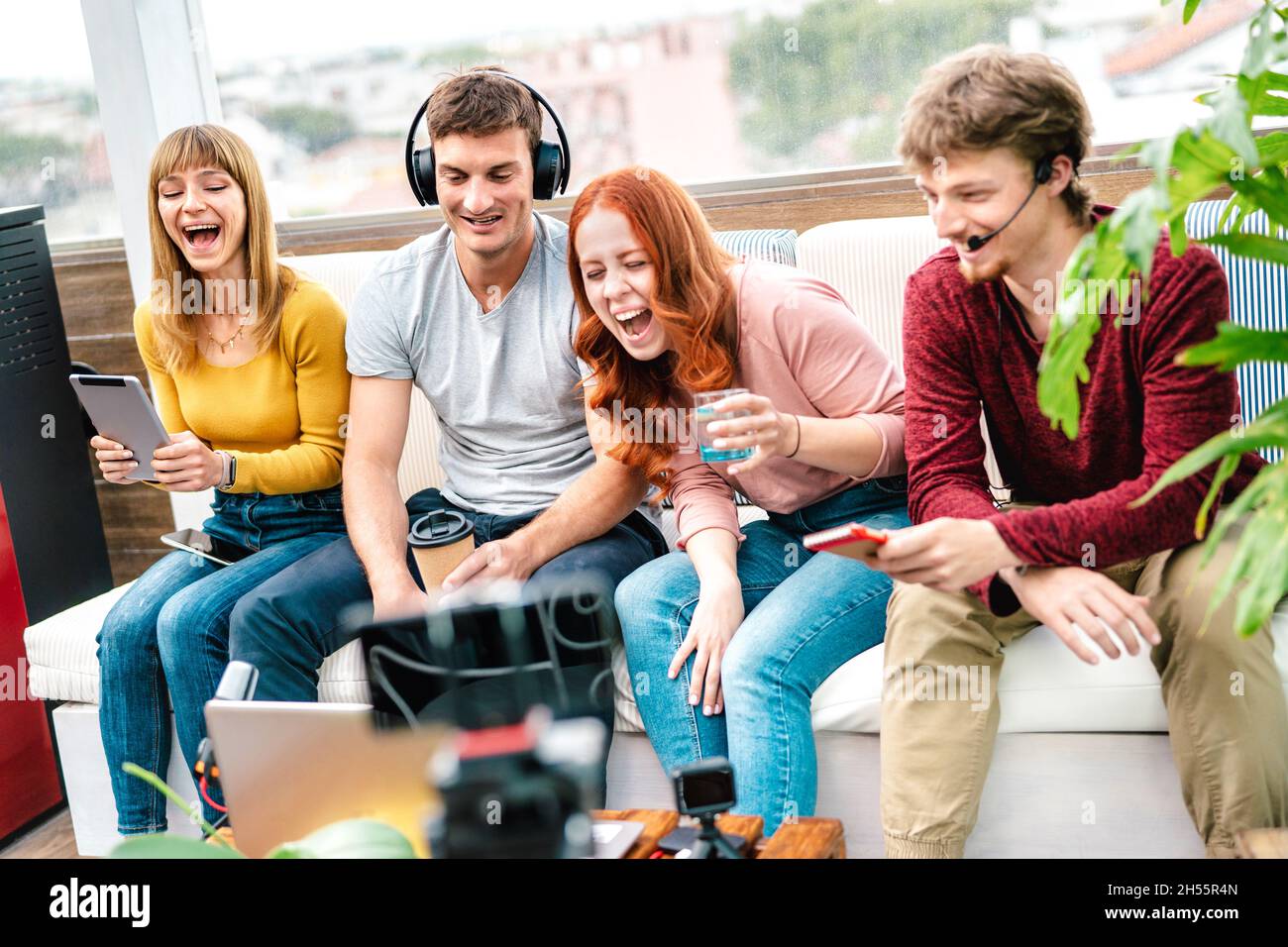 Young friends influencer having fun on streaming platform with web cam - Content marketing concept with millennial guys and girls sharing live vlog Stock Photo