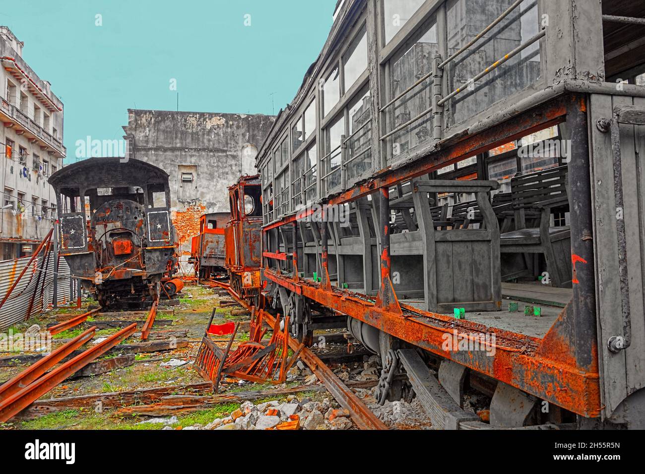 Rusty and old steam locomotives and freight cars abandoned in a yard in central Havana, Cuba. Stock Photo