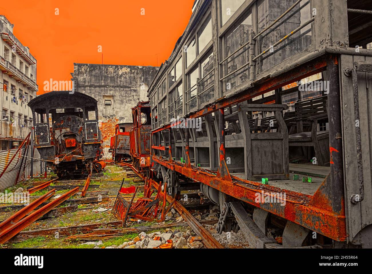 Rusty and old steam locomotives and freight cars abandoned in a yard in central Havana, Cuba. Stock Photo