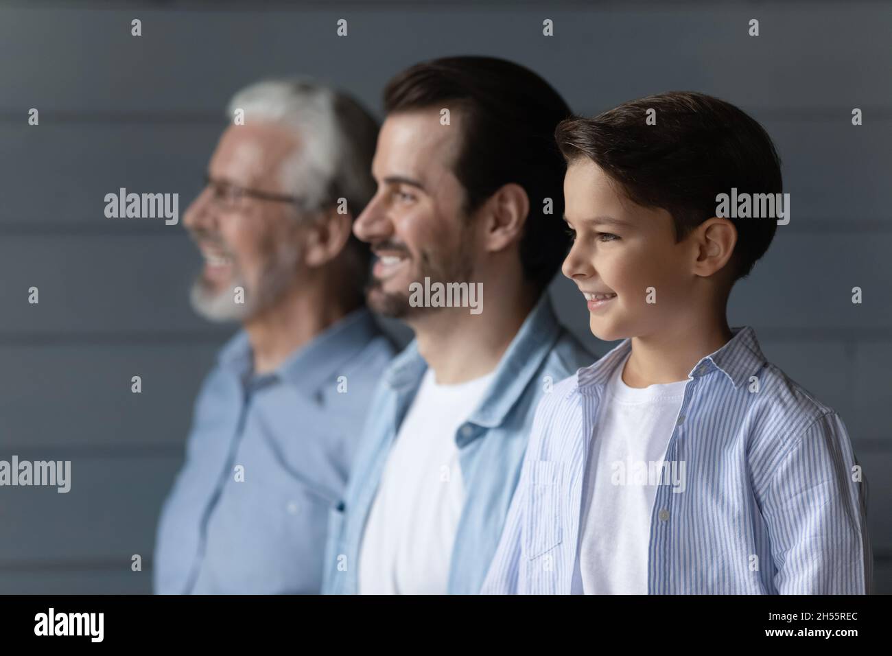 Family dynasty of 3 diverse males stand in line together Stock Photo
