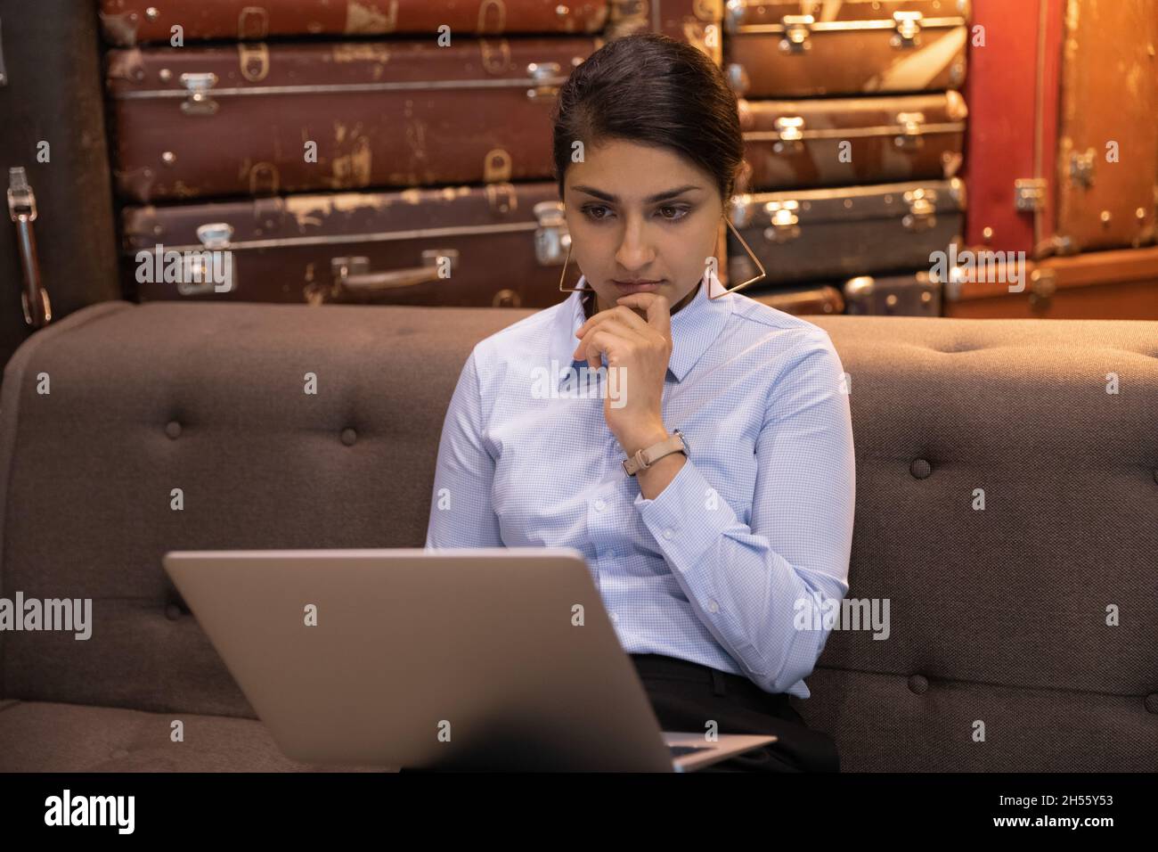 Focused thoughtful young indian businesswoman working on computer. Stock Photo