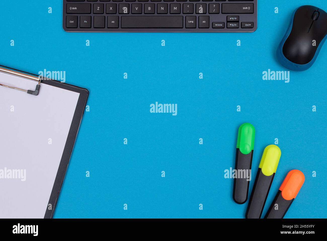 Office Workplace with Digital Gadgets Lying on Blue Table - Flat Lay Stock Photo