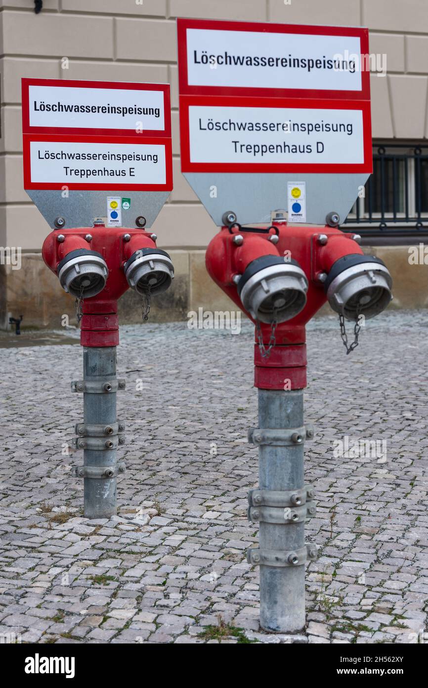 Double line of a fire fighting water supply for a building from the street with focus on the rear line Stock Photo