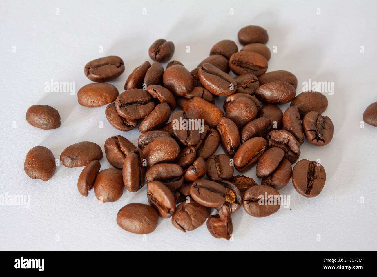 Pile of roasted coffee beans isolated in white background Stock Photo ...