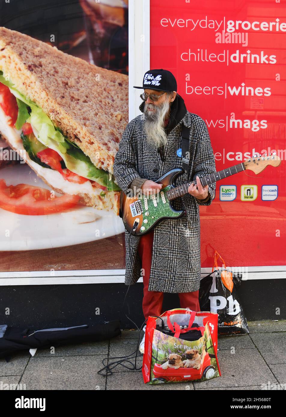 Man busking with electric guitar in Todmorden in Upper Calder Valley in