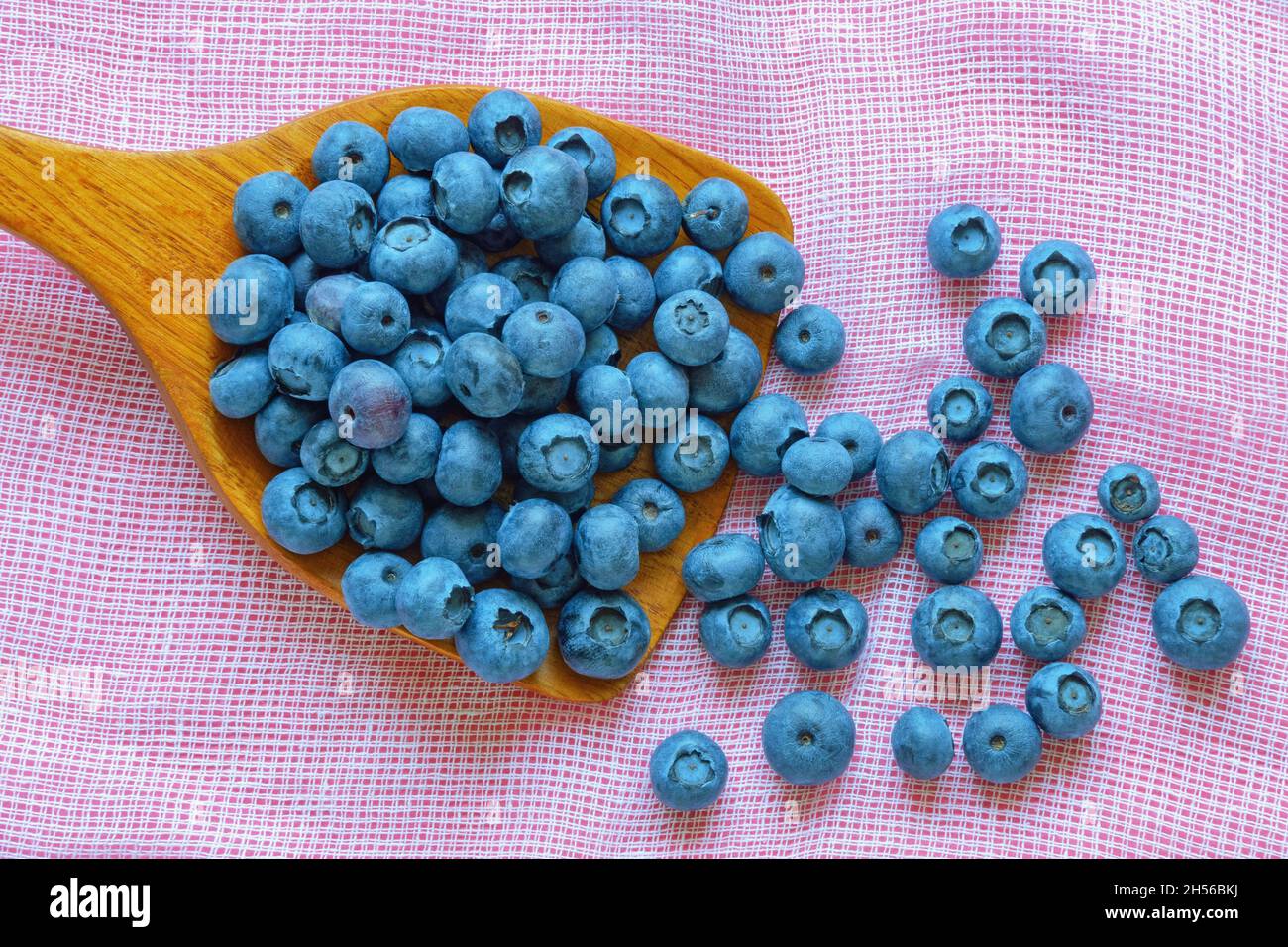 Wild berry. Bog whortleberry on wooden spoon on table Stock Photo
